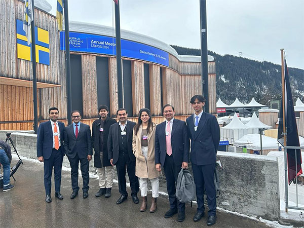 Adani Group Chairman Gautam Adani (in the centre) at World Economic Forum with a few other delegates (Image: LinkedIn/Gautam Adani)