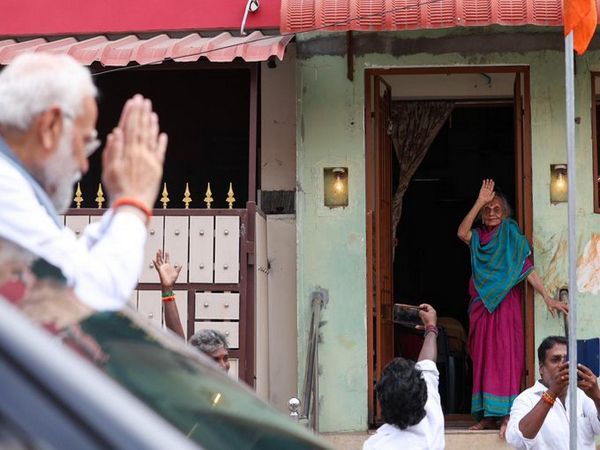 Prime Minister Narendra Modi greets an elderly woman during roadshow ahead of temple visit in Tamil Nadu (Photo/ANI)