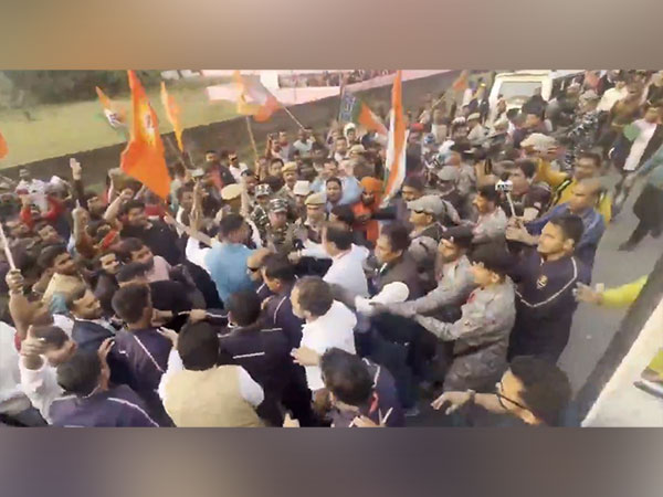 Congress leader Rahul Gandhi stepping out of bus to meet crowd with BJP flags (Photo Courtesy: himantabiswa/X)