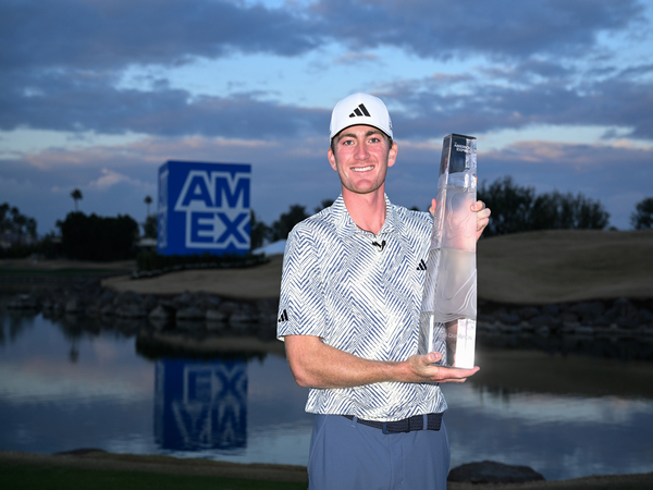 Golfer Nick Dunlap lifting The American Express trophy (Image: PGA)