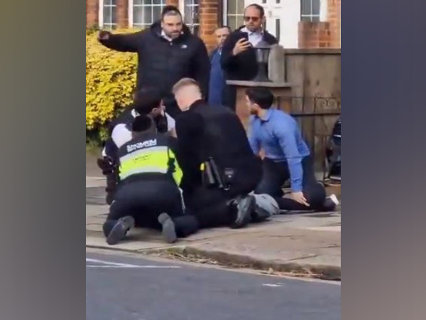 A screengrab of video showing police and others detaining the man in Golders Green, London (Photo/@CST_UK)