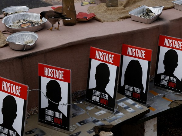 An installation featuring dinner settings with empty seats, representing the hostages kidnapped in the Oct 7 attack on Israel, in Tel Aviv (Photo/Reuters)
