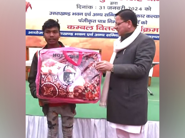 Uttarakhand Chief Minister Pushkar Singh Dham distributes blankets to workers (Photo/ANI)