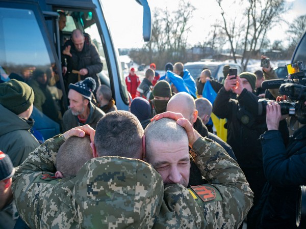 Ukrainian serviceman embraces POWs after a swap at an unknown location in Ukraine (Photo/Reuters)