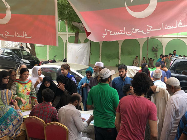 Voters queue up at a PTI bench near the voting centre (Image Credit: X/@PTIofficial)