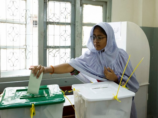 A woman reaches out to a ballot box to cast a vote at a polling station during the general elections in Pakistan (Photo/Reuters)