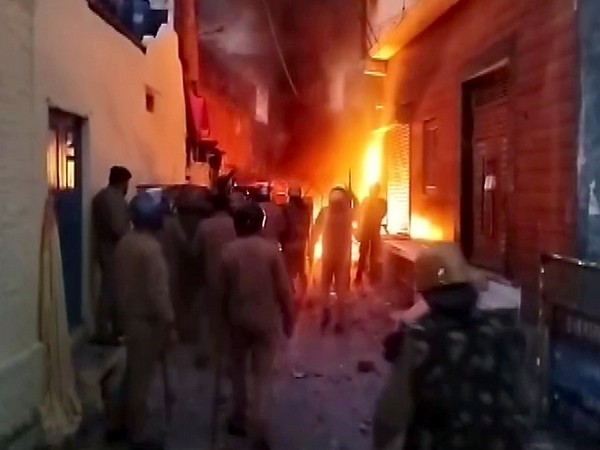 Police personnel stand guard after violence broke out at Banbhoolpura (Photo/ANI)