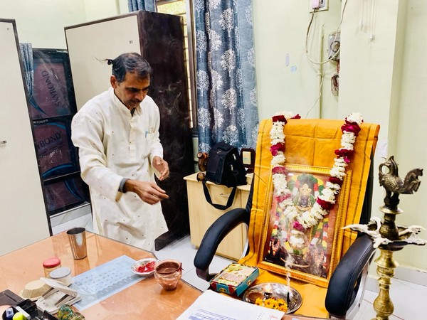 The principal worshiping Lord Ram on his chair (Photo/ANI)