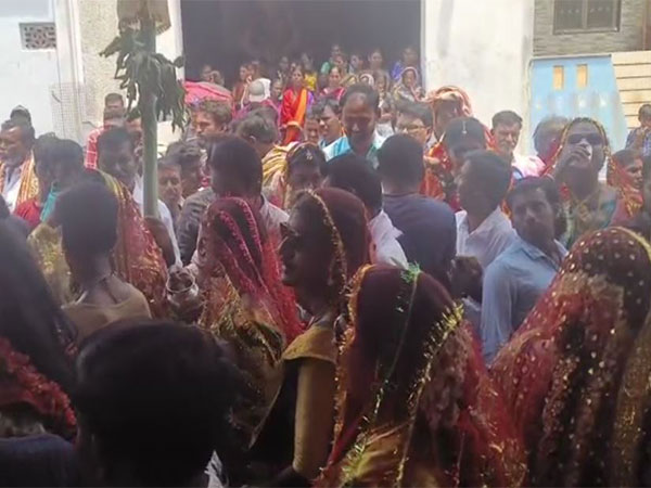 Men embrace women's attire as part of Holi celebration in Santhekudlur. (Photo/ANI)