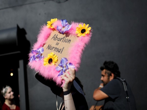 An abortion rights protestor holds a sign after the landmark Roe v Wade abortion decision was overturned in Miami, Florida in June 2022  (Photo/Reuters)