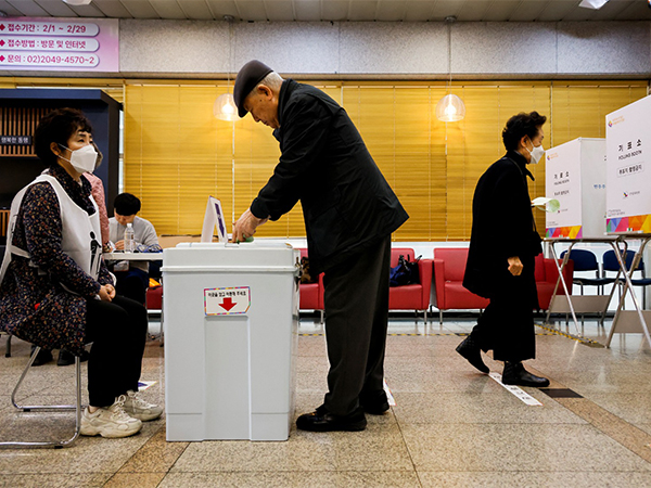 People vote at a polling station for parliamentary election in Seoul (Image Credit: Reuters)