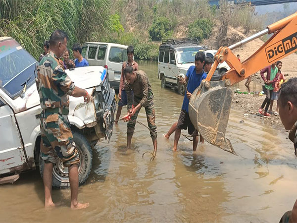 Assam Rifles recovering the vehicle from the Sekul River in Mizoram (Photo/ANI)