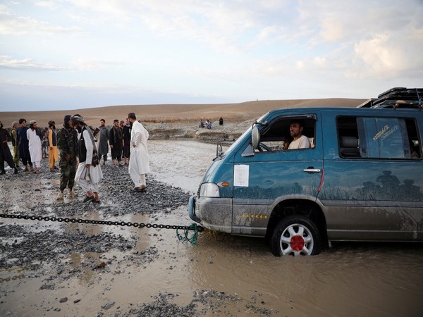 A mini van being towed out of flood water in Afghanistan. (File Photo/Reuters)
