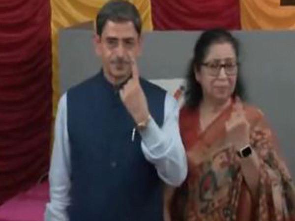 Tamil Nadu Governor RN Ravi and his wife Lakshmi posing to cameras after casting vote (Photo/ANI)