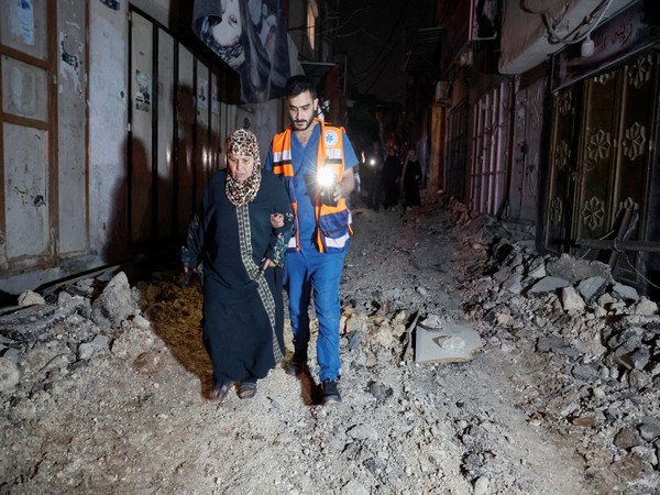 People walk on damaged street after Israeli raid at Nur Shams camp (Image Credit: Reuters)