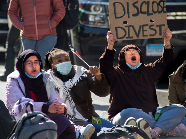 Protestors gather at the corner of Grove and College Streets (Photo/Reuters)