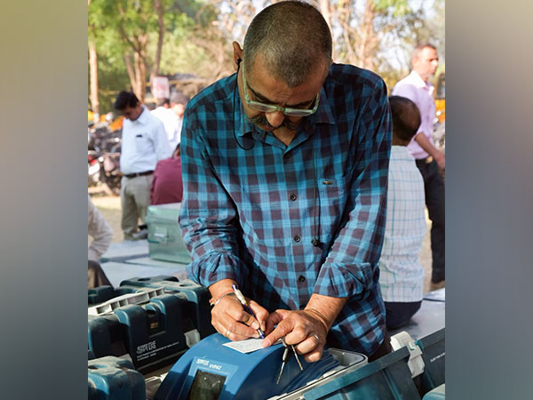 A polling official collects an EVM and other polling materials at a distribution centre in Meerut on April 25, 2024 (Phot/ANI)