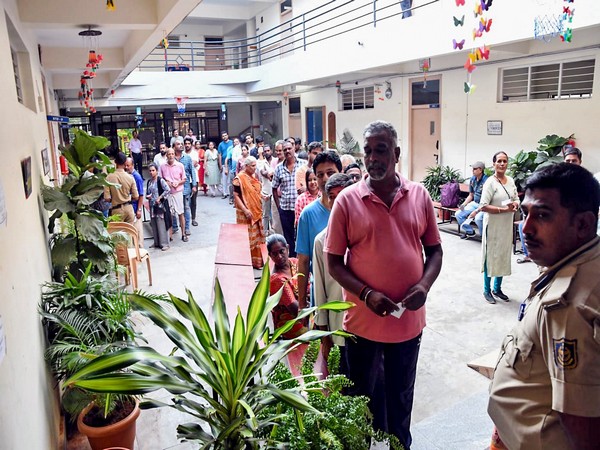 Bengaluru: Voters stand in a queue to cast their votes (Photo/ANI)
