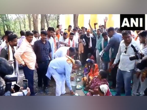 BJP's Dharmendra Pradhan serves food to party leaders and supporters (Photo/ANI)