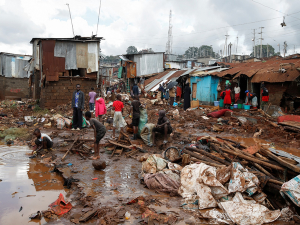 Residents recover their belongings after Nairobi river burst its banks and destroyed their homes within the Mathare Valley settlement in Nairobi (Image Credit: Reuters)