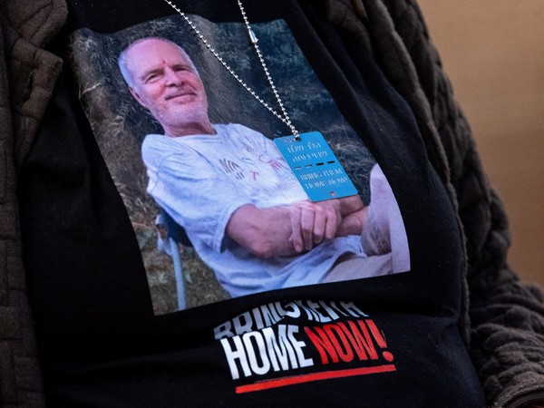 A picture of Hamas hostage Keith Siegel is worn by his wife Aviva at the UN in Geneva (File Photo/Reuters)