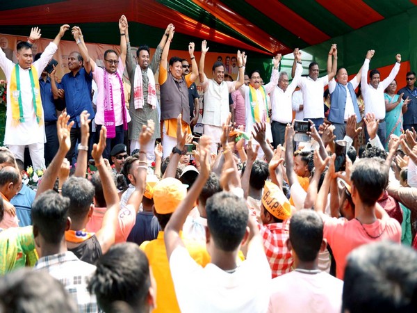 Assam CM Himanta Biswa Sarma with BJP leaders join hands during an election campaign rally (File Photo/ANI)
