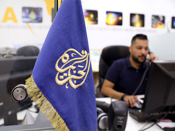 An employee works inside the office of the Qatar-based Al-Jazeera network in Jerusalem (File Photo/Reuters)