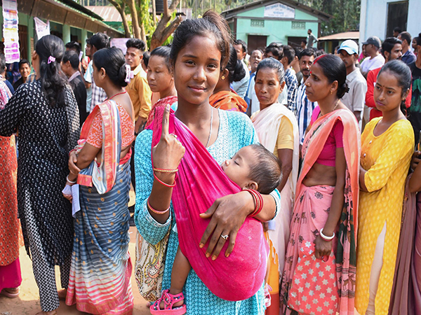 A voter shows her ink-marked finger after casting her vote for the second phase of the Lok Sabha elections in Morigaon district of Assam on Friday. (Photo/ANI)