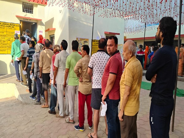 Voters queue up outside polling booth in Gwalior (Photo/ANI)