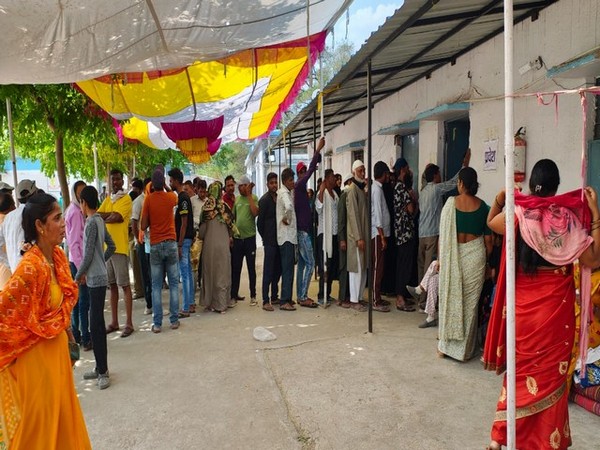 Voters queue up outside polling booth in Bhopal (Photo/ANI)