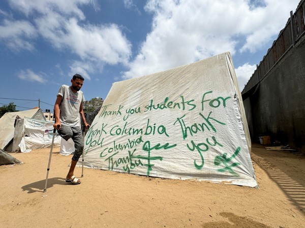 A man uses crutches next to a tent, in Rafah (Photo/Reuters)