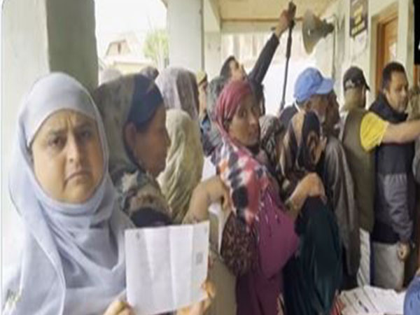 Voters queue up outside a polling booth in Ganderbal (Photo/ANI)