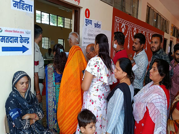 Voters queue up outside polling booth in Indore (Photo/ANI)  