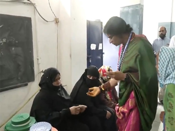 BJP candidate Madhavi Latha checks voter identity cards (Photo/ANI)