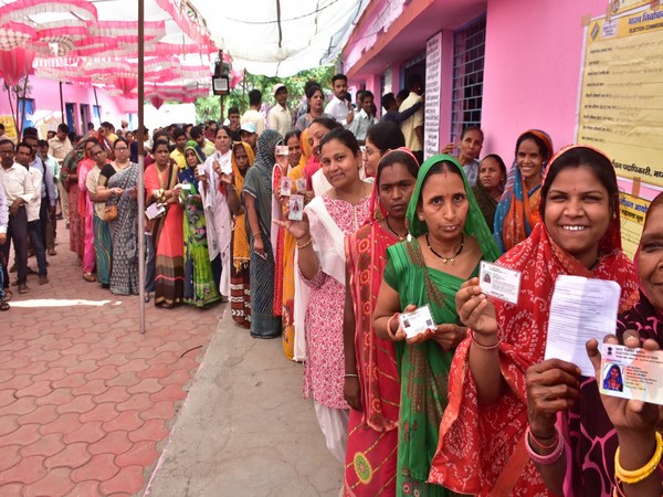 Voters queued up outside a polling booth in Ujjain (Photo/ANI)  
