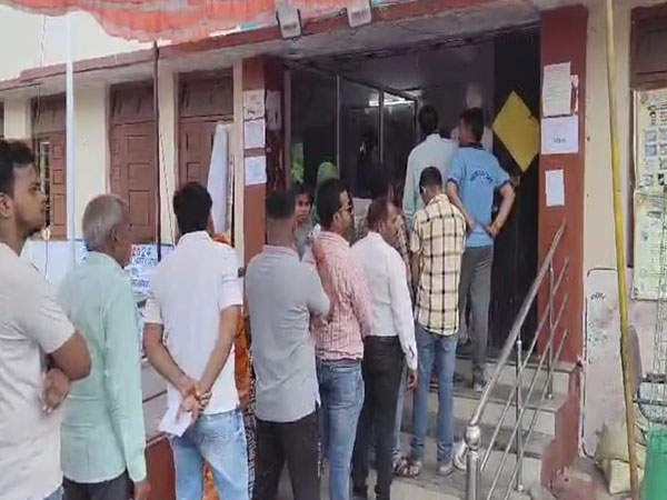 Voters queue up outside a polling booth in Dhar (Photo/ANI)  