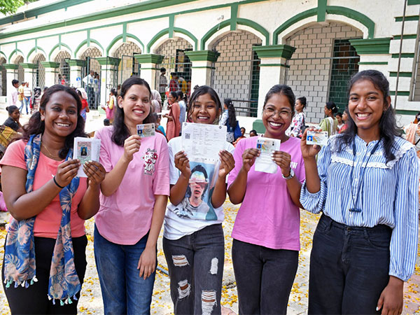 First-time voters show their voting documents as they arrive to cast their vote in Khunti. (Photo/ANI)