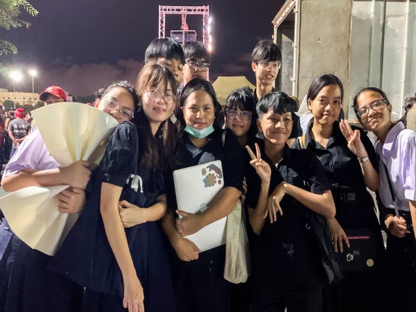 Netiporn Sanae-sangkhom poses for photographs with members of the 