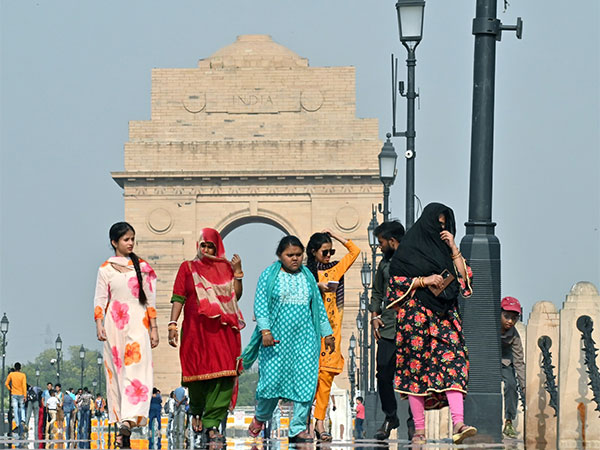 People use scarves to cover themselves during a hot summer day (File Photo/ANI)