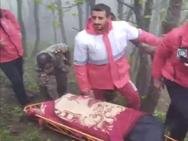 Rescue workers carry bodies of victims of May 19 helicopter crash in which Iran President Raisi died. (Photo credit/Press TV)