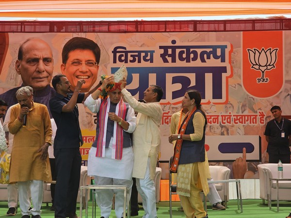 Defence Minister Rajnath Singh with party workers at a public meeting in Delhi’s Najafgarh. (Image: ANI)