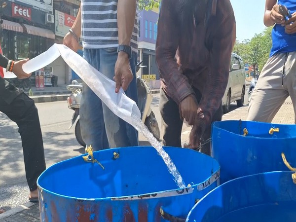 Locals filling a tub with water in Kathua (Photo/ANI)