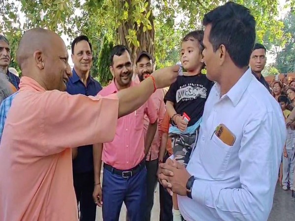 CM Yogi engages with Children, distributes chocolates during Gorakhpur Temple visit (Photo/ANI)