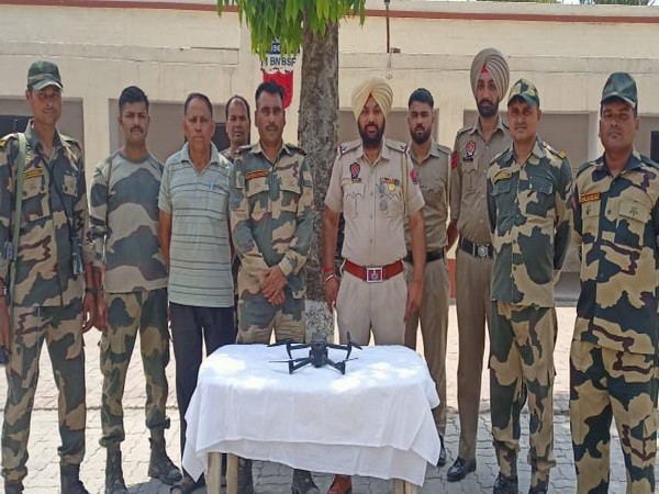 BSF troops with the recovered drone. (Photo/ANI)
