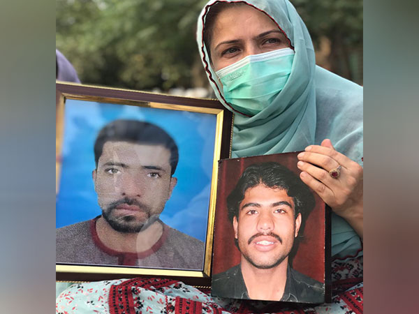 Saeeda Baloch holds picture of her brother Sajjad and her nephew Zahoor (Image Credit: X)