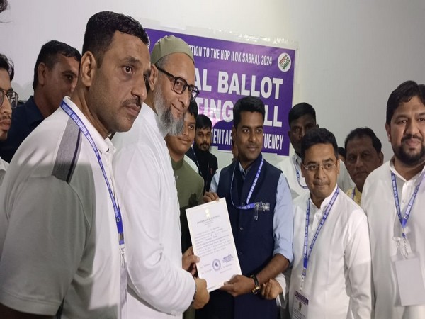 AIMIM chief Asaduddin Owaisi receives his winning certificate. (Photo/ANI)
