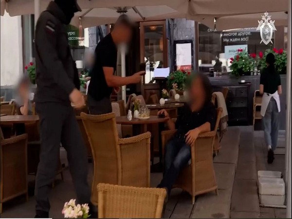 A screengrab of a video released by the Russian Investigative Committee shows the man being arrested by security personnel at a cafe in Moscow. (Photo/Russian Investigative Committee)