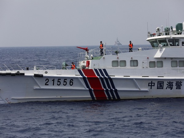 Chinese Goast Guard personnel are seen onboard its vessel while sailing in the South China Sea (File Photo/Reuters)
