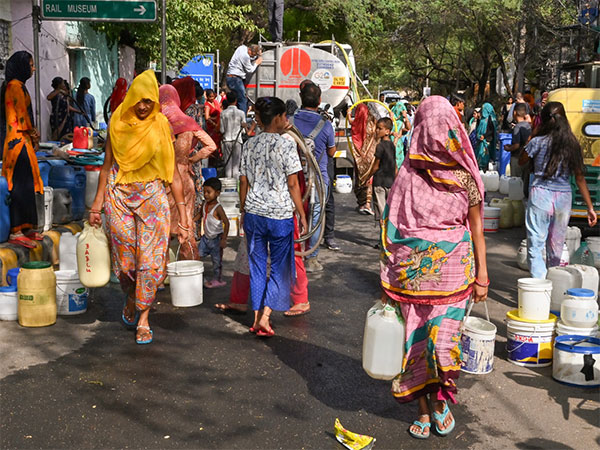 People fill their buckets from a water tanker as water crisis continues in New Delhi. (Photo/ANI)