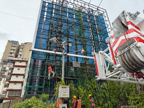 Hoarding being removed in Mumbai by authority (Image: MHADA)